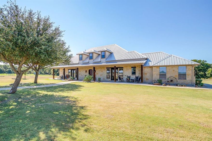This 3,800 sq ft stone home has been fully remodeled with new appliances, fixtures, paint, carpet, and décor throughout. This Texas Luxury Ranch residence on over 46 acres w exquisite style &design that is located only 37miles W of FtW in the desirable Millsap. This home is privately nestled at the end of the picturesque treed entry &drive that weaves between flowing pastures that currently produces hay, but can graze cattle, or build your custom equine facility. Elegantly designed for entertaining your guests or escape in the country with abundant amenities and privacy this property has all the opportunities. As your guests enter the front door they’ll step into the impressive Great Room w 12’ beamed ceiling & glowing stone fireplace.The dining comfortably accommodates guests w French doors that open to the covered porch that overviews the rolling pastures.The kitchen has a large granite island &gas cooktop.Enjoy meals in the dining nook overlooking the back patio fireplace&pizza oven that is elegantly designed reflecting the seasonal creek. Every window entices w views of pastures, woods, and seasonal creek.The private side of the home are 2ensuite bedrooms including the master w fireplace &office.Upstairs are 2 bedrooms &2ensuite bathrooms along w an office. Outdoor living space,large shop w2stalls,120x240 arena&multiple loafing sheds. Too many Amenities to List!