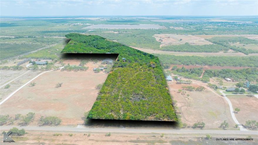 22 acres in the Abilene city limits presents a new owner with a variety of directions for use.  Densly thicketed with mesquite, one could refurbish the old homesite with a new home and enjoy a retreat from Abilene literally minutes from I-20 and town.  Alternatively, you have nearby zoned mobile home land use - this gives precedent for a conversation with the City's planning department to see about transforming to an RV or mobile home park to capitlize on the burgeoning need for housing fueld by the Lancium data center to several miles to the west or the Frontier data center in Shackleford County. Across Calwell you have new single-family home development - take the residential use of this property a more permanent direction with simliar development. This is an interesting piece of property with its old farmhouse and brick silo turned treehouse. The property slopes to the east where Cedar Creek - which typically has water year-around - defines the eastern boundary and places roughly 15 of the 22 acres of this tract in flood zone.