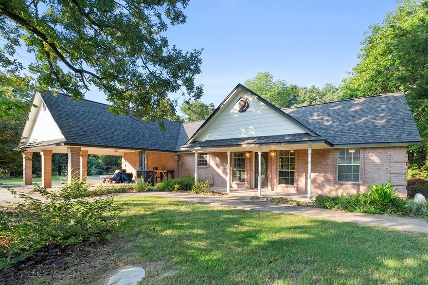 Nestled among mature hardwoods near Richland Chambers Lake, this brick home offers privacy, space, and peaceful surroundings that feel like your own retreat. A long, tree-lined drive welcomes you in and sets the tone for what’s inside, including vaulted ceilings, a cozy fireplace, and built-ins that add both character and function. The oversized primary suite overlooks the wooded landscape and features a bath with a jetted tub and separate shower. A large bonus room provides flexibility for a home office, additional living area, or game room. Step outside to enjoy the screened porch, pergola swing, and shaded backyard, all just minutes from lake access. If you are looking for a property that combines quiet surroundings with convenient proximity to Richland Chambers Lake, this home offers both comfort and versatility.