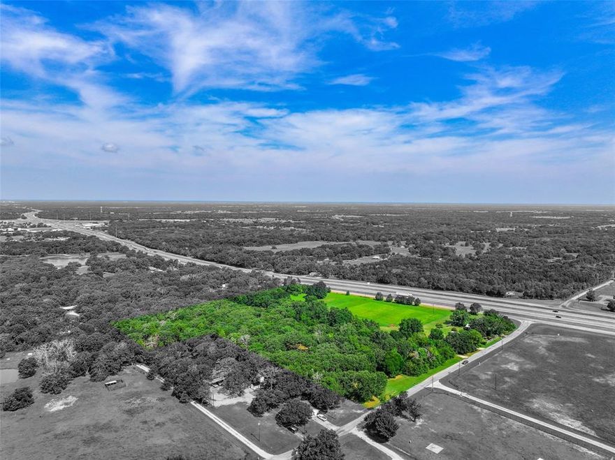 This 18.38-acre, 2-parcel property on Interstate 30 in Campbell, TX, offers an exceptional opportunity for a single-family residence or commercial development. Equipped with city water, electricity, and septic, the property boasts a picturesque landscape with a pond and large oak trees, all situated outside of any flood zones. Located outside city limits on a corner with two access points, the site features approximately 800 feet of interstate frontage, ensuring high traffic exposure with over 33,000 vehicles passing daily. This prime visibility and accessibility make it ideal for various developments. Note that the second home on the property is excluded but negotiable. Embrace the endless opportunities this property presents. Whether you envision a serene residential haven or a thriving commercial enterprise, this unique parcel provides the perfect canvas to bring your dreams to life. Don’t miss out on the chance to secure a prime piece of real estate with unparalleled potential!