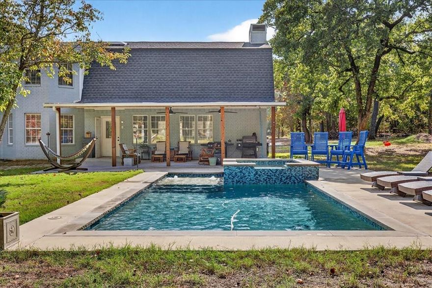 Discover your own private getaway on 12.75 gated and beautifully maintained acres! This 4-bedroom, 2.5-bath home offers incredible space with soaring vaulted ceilings, an open-concept layout, and granite countertops throughout. The dedicated office is perfect for remote work or personal projects. Step outside to a peaceful, wooded backdrop where you can relax or entertain on the covered back porch overlooking the sparkling swimming pool and hot tub. Outdoor enthusiasts will love the seclusion, abundant wildlife, and endless room for recreation. The impressive heated and cooled shop is currently set up as a game room—complete with pool table and shuffleboard—ideal for gatherings year-round. Whether you’re seeking a quiet retreat, a hunter’s paradise, or a property built for entertaining, this one checks every box. Serenity, space, and fun all in one place ! Survey and T-47 provided. Buyers will need to purchase a new survey if needed. Buyers and buyers agents are responsible to confirm all information provided. Washer, dryer, and refrigerator will convey with the home.