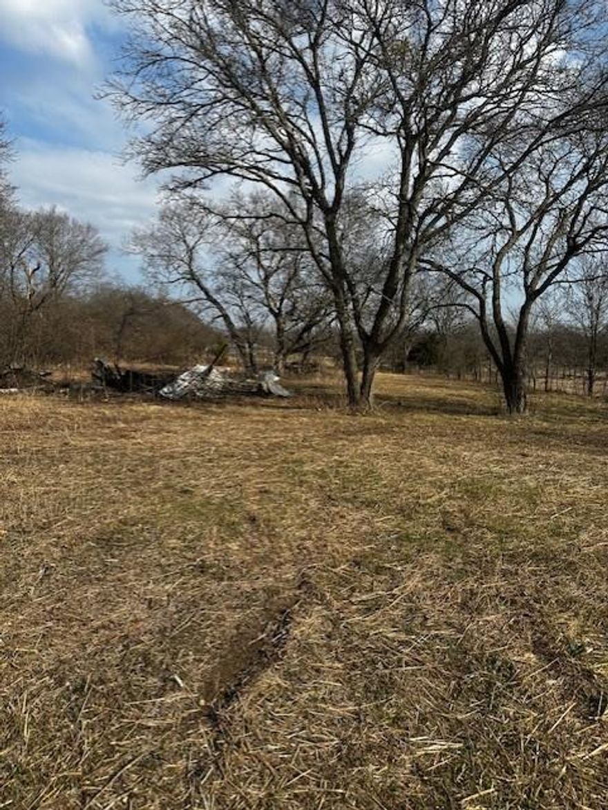 Located within the City of Bells, this lot sets back behind and beside two more lots listed by the same owner on MLS numbers 21177971 and 21177941.  At one time this lot had both city water and a septic tank. A water meter box located on the east edge of the property near Ford Street and is marked by orange paint. The house was bulldozed down and the lot cleared.  A great place to build a home with plenty of room for outdoor activities.  All information is believed to be true and accurate by owner and listing agent.  Buyer and buyer's agent is responsible and encouraged to verify and do due diligence on all information.