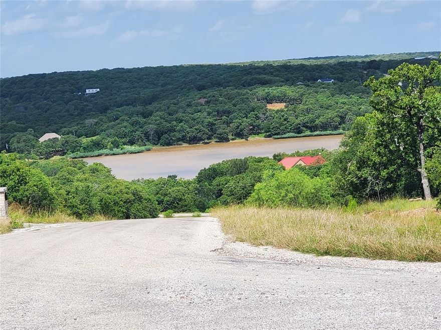 Beautiful corner lot with partial lake view. SLR is a master-planned community with 2,300 acres of rolling hills & hardwood forests. Located on Amon G. Carter Lake, SLR appeals to anyone looking to escape the busy city, but still be convenient to the Metroplex. Residents can simply walk outside to enjoy remarkable sunsets or marvel at the wildlife from deer & turkey to an amazing variety of birds & wildflowers. Whether you are looking for a permanent residence, a retirement home, or a weekend getaway, SLR offers the perfect lifestyle in a beautiful setting. This private community features 2 fishing lakes, RV & boat storage, security, swimming pool, on-site fire hall, gym, community center & more.