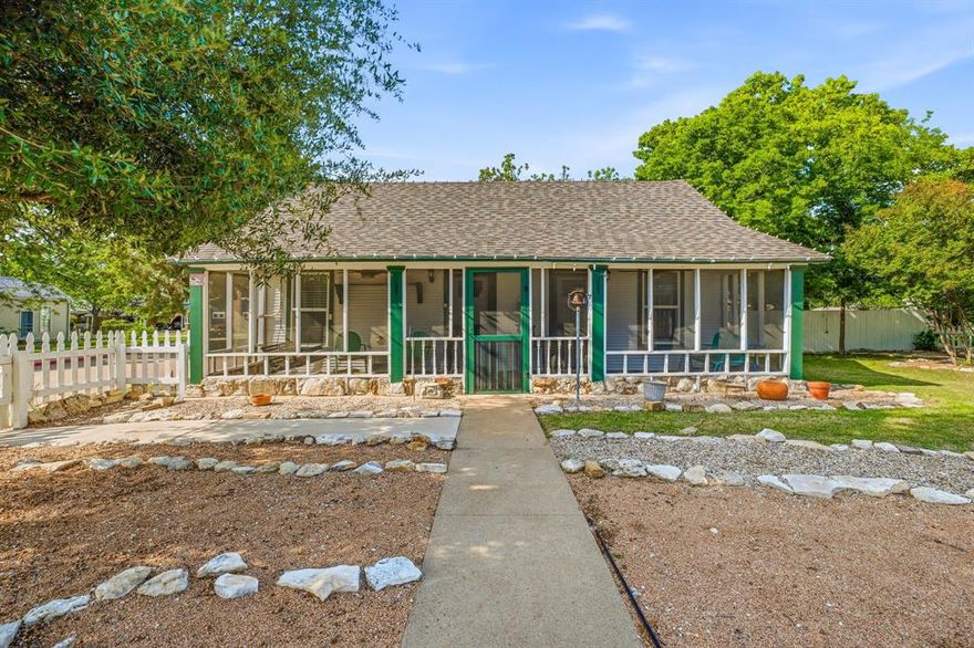 Built in 1877 and thoughtfully restored, this historic Granbury cottage offers a rare opportunity to own a true piece of Hood County history just moments from the Historic Downtown Square. Situated on a full lot in the desirable Historic District, this 2-bedroom, 1-bath home blends original character with functional updates for modern living.

From the inviting screened-in front porch to the preserved interior details, the home reflects the craftsmanship and charm of its era. Inside, you’ll find warm wood accents, a comfortable layout, and natural flow between the living, dining, and kitchen spaces. The bedrooms are privately positioned, making the home both practical and welcoming.

The outdoor space is designed for both enjoyment and ease, featuring mature trees, established landscaping, and multiple areas to relax or entertain. The full lot provides added space and flexibility that is hard to find this close to the Square.

A standout feature of the property is the detached carriage house, offering additional potential for storage, workshop space, or future improvement. Opportunities like this—combining historic character, a full lot, and proximity to Granbury’s most sought-after destination—are rare.

Whether you’re looking for a primary residence, weekend retreat, or investment opportunity, this property delivers location, charm, and upside.