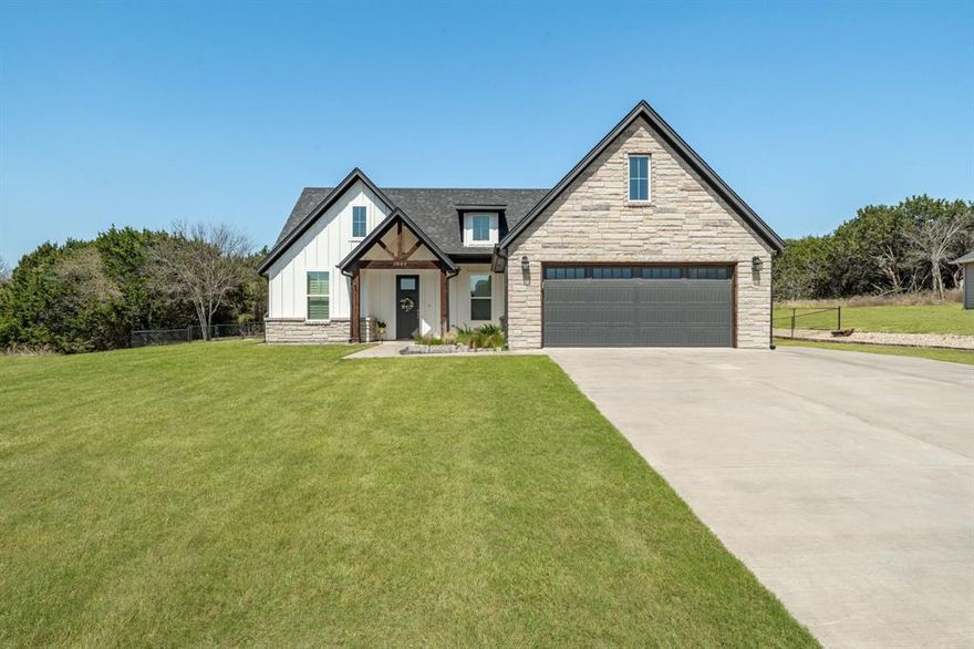This stunning 3-bedroom, 2-bathroom modern farmhouse-style home is situated on over half an acre in Indian Harbor Subdivision. Featuring an open-concept layout, the home boasts beautiful ceramic tile flooring throughout, creating a seamless flow from room to room.
The spacious kitchen is a standout, with a large navy blue island, sleek granite countertops, and high-end stainless steel appliances. A sizable walk-in pantry provides plenty of storage. Coffered ceilings in the living area add elegance, while the modern electric fireplace creates a warm, inviting atmosphere.
Natural light fills the home through numerous windows, all outfitted with plantation shutters for style and privacy. The primary suite offers a luxurious retreat with a large walk-in closet and an en-suite bathroom featuring a walk-in shower and a separate garden tub.
Step outside to enjoy the expansive backyard, complete with a 16x12 storage shed on a concrete slab, providing additional space for tools, equipment, or hobbies. Front and backyard irrigation.
Built by Stella Rose, this home combines modern design with exceptional craftsmanship, making it the perfect place to call home in Indian Harbor.