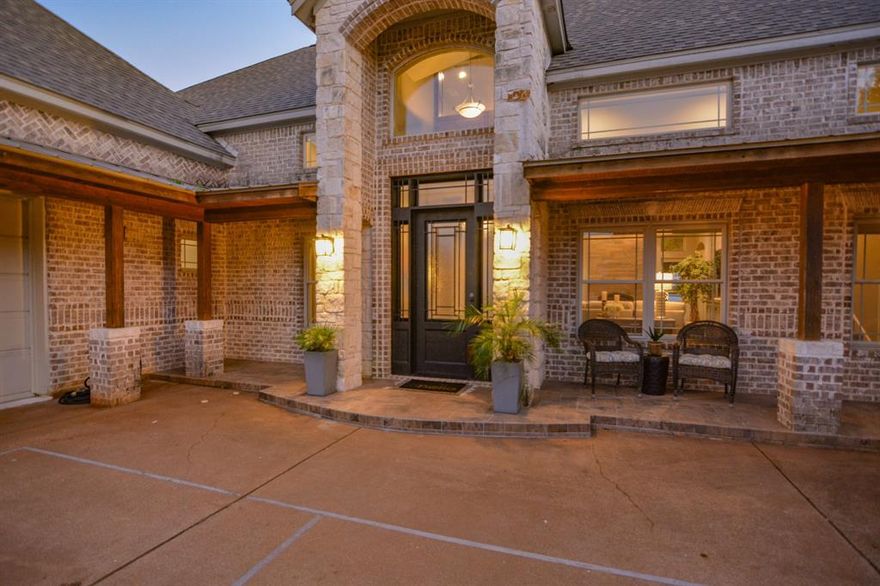 Experience serene lakefront living in this stunning two-story, 3,368-square-foot brick home fronting a private ski lake with close by convenient access to launch your boat into Lake Granbury. Designed to maximize natural light and capture breathtaking water views, the home features expansive windows across the back, creating a bright, airy atmosphere and a seamless connection to the outdoors.

The family room is the heart of the home, offering high ceilings, large picture windows, and an open layout that flows effortlessly into the chef’s kitchen, perfect for entertaining and relaxed lake living.

The primary suite is a true retreat, complete with a cozy fireplace and panoramic lake views. The ensuite bath offers a spa-like experience with a free-standing soaking tub, separate walk-in shower, dual vanities, and his-and-hers walk-in closets. A convenient stackable washer and dryer add functionality to this luxurious space.

With four bedrooms three and one half baths, this home provides plenty of room for family and guests. Thoughtful storage solutions are found throughout, and two attached garages offer ample space for vehicles and lake toys.

Enjoy outdoor living at its best with an exterior shower—perfect after a day on the lake—and a sprinkler system that keeps your lawn lush year-round. Accent lighting showcases the beauty of the home from both the road and the lake, making it a standout day and night.

This exceptional property blends comfort, style, and convenience—ideal for those seeking the perfect lakefront lifestyle.