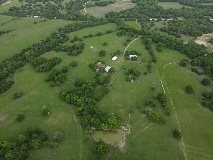 Escape to the country with this exceptional farmhouse estate on 160 acres in Bowie offering space, functionality, and breathtaking views. Currently under Ag exemption and set up for cattle, this property is ideal for ranching, recreation, or a private retreat with a seasonal creek running throughout. The main farmhouse is full of charm and complemented by an additional guest house perfect for extended family, visitors, or rental potential after some TLC. A 30x40 shop provides ample room for equipment, hobbies, or storage. Enjoy stunning landscapes, wide open skies, and the peace of country living while being just minutes from town. Property also is fenced with storm cellar for added security and peace of mind. Rare opportunity to own a versatile North Texas ranch with endless possibilities.
