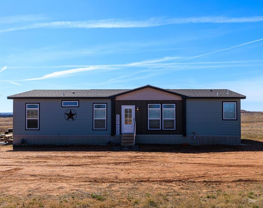 Welcome to peaceful country living with this 2023 manufactured home situated on 10.05 acres of wide-open land, ready for you to make it your own. Offering 1,680 square feet, this 3-bedroom, 2-bath home features a spacious open-concept layout with a large living area, dining space, and an electric fireplace that creates a warm focal point. The kitchen is designed for both function and style, boasting granite countertops, a large island, and plenty of cabinet space for storage and entertaining. The primary suite provides a private retreat with a generous bedroom, ensuite bathroom featuring a large walk-in shower, a soaking tub, and ample space to unwind. Two additional bedrooms and a full bath offer comfortable accommodations for family or guests. Outside, the expansive acreage offers endless possibilities for animals, recreation, gardening, or building additional structures. A water well is already in place, providing a valuable resource for your rural lifestyle. If you’ve been dreaming of space, privacy, and the freedom to create your own homestead, this property is ready to welcome you home.