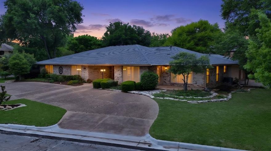Beautiful, stately home in highly sought-after Interlochen Estates in Arlington! Offering nearly 4,200 sq ft, this impressive, single story 4-bedroom, 3.5-bath residence with 3-car garage blends elegance, comfort, and thoughtful design throughout. The open-concept floor plan is highlighted by stunning stone archways, a grand stone fireplace, and walls of windows and French doors along the back that flood the home with natural light and showcase serene garden views. Perfect for entertaining, this home has two separate dining rooms, an expansive great room, and additional family room all flowing together seamlessly, yet with defined boundaries. All bedrooms are generously over-sized and feature direct ensuite bathroom access and large closets. This home has abundant storage, custom built-ins, and a walk-in cedar closet. The large primary suite offers his & hers closets, dual sinks, a separate vanity, soaking tub, large shower and access to one of the patios in the backyard. The chef’s kitchen is both tasteful and practical. It is equipped with a luxury Viking professional gas double oven and range with griddle, indoor grill and custom vent hood. A large island with prep sink, appliance garage and ample cabinetry and counterspace make this kitchen a chef's dream! A standout feature of this home is the flexible guest or in-law suite privately located off the oversized laundry room. This area is complete with its own sitting room, bedroom, full bath and exterior door with private patio—perfect for multi-generational living or extended stays. The tiled 3-car garage adds a polished touch. Outside you will find the beautifully landscaped backyard which offers a tranquil, garden-like setting with two separate seating areas and the neighborhood's signature canal views. A full roof replacement was done in 2023 for added peace of mind. Interlochen Estates is known for its scenic canals, mature trees, and rolling hills, making this a truly exceptional place to call home.