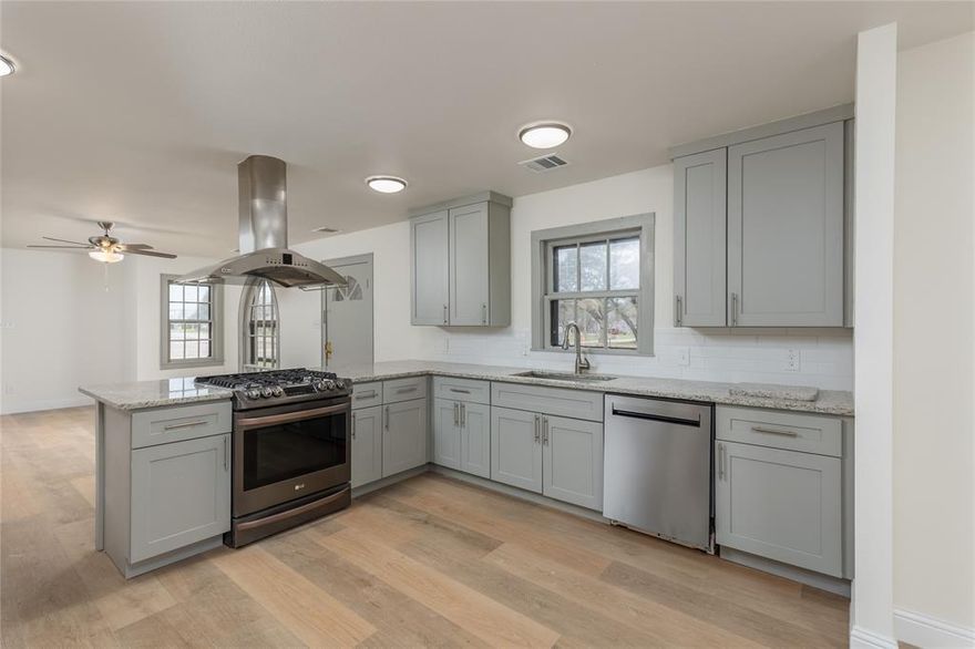 Step into timeless character with modern peace of mind in this beautifully renovated 1940s home, uniquely crafted from distinctive natural river rock. Situated on a spacious corner lot of over one-quarter acre, this property offers the charm of historic architecture with the confidence of extensive updates. 4 Bedrooms or 3 Bedrooms with an Additional Living Area on 2nd level.  Nearly every major component has been replaced or upgraded, including a new roof, HVAC system, attic spray foam insulation, plumbing, electrical wiring (outlets and switches), tankless water heater, and a brand-new gas line from the street with new meter installation. The entire home features new drywall, updated lighting, ceiling fans, baseboards, and flooring throughout — with new flooring downstairs and fresh carpet upstairs. The remodeled kitchen boasts new cabinetry, backsplash, sink, and faucet, blending functionality with style. Both bathrooms have been completely updated with new tile showers, toilets, vanities, sinks, and fixtures, creating fresh, modern spaces while preserving the home's vintage appeal. Additional exterior door upgrades from the kitchen and garage further enhance functionality and access. The oversized lot provides ample space for outdoor living, gardening, entertaining, or future expansion — a rare find within city limits. Conveniently located near Jacksboro schools, local shopping, dining, and everyday amenities, this home also offers easy access to Highway 281 and Highway 380 for commuters. Enjoy the charm of small-town living with proximity to Fort Richardson State Park, the historic downtown square, and Lake Jacksboro for fishing, boating, and recreation. This is a rare opportunity to own a fully updated historic home with character, space, and modern systems already in place.