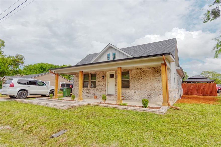 Don't let the 1925 date fool you — this home was essentially reborn in 2022 with all-new HVAC, electrical, and plumbing, plus full foam insulation that makes it as efficient as anything built new today. Sitting on a corner lot in the heart of Tioga, this 3-bedroom, 2-bath home delivers 1,632 square feet of thoughtfully designed living space with an open floorplan, luxury vinyl plank flooring throughout, and finishes that punch well above its price point.

The kitchen is the heart of the home — featuring a large island with seating, built-in gas range, quartz countertops, built-in wine cooler, pantry, and a layout that flows naturally into the living area. The primary suite offers a true retreat with dual sinks, garden tub, separate shower, walk-in closet, and an ensuite bath finished to match. 

The utility room includes built-in cabinets, a sink, and full-size washer & dryer connections.

Step outside and you'll find a backyard built for living — covered gazebo with lighting, stone fire pit, artificial turf, concrete patio, and a 13x20 carport with 11-foot clearance. The 18x20 shop with 8-foot sidewalls and electrical is ready for tools, toys, or a workspace. 

Corner lot location means extra room to breathe.

All this in Tioga ISD, with city water, city sewer, and individual gas meter. Move-in ready with nothing left to do but enjoy it.