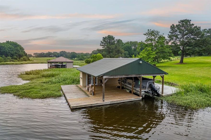 Perfect for either a weekend retreat or full time residency, this incredibly spacious lakefront home features 180 linear feet of shoreline on a two-acre lot. Situated in arguably the most beautiful part of Lake Athens, the tree-shaded grounds offer beautiful views and abundant wildlife.  Enjoy world class bass fishing right off the large boathouse or wake up to the site of a herd of deer grazing just outside the back door. The home has two primary suites (one on the ground floor and one upstairs), a large bunk room, and several flex spaces. With a new roof and new exterior and interior paint, the well-built home is ready for your new vision inside.