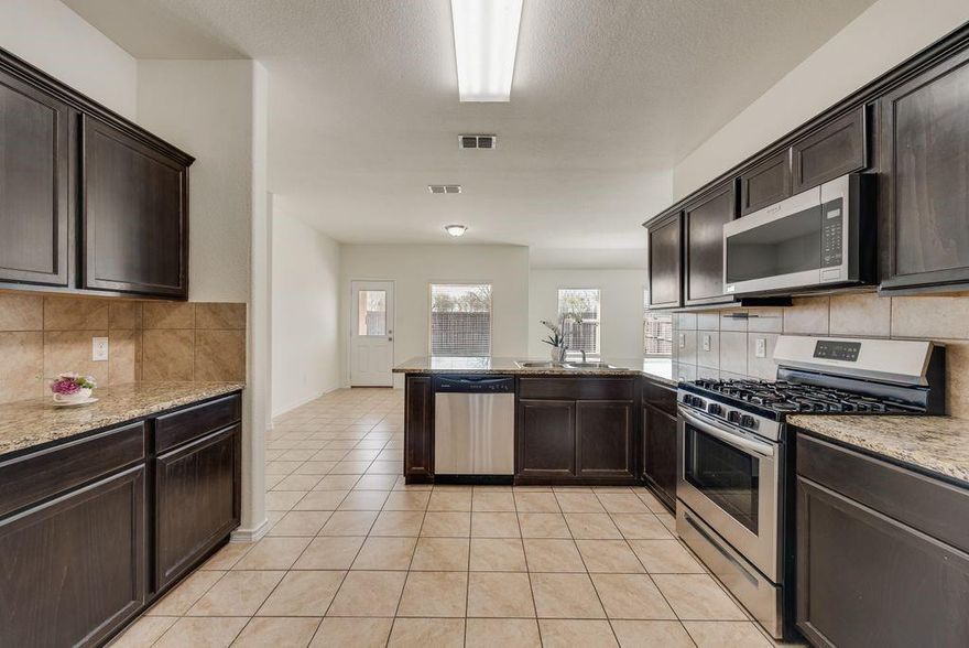 This turnkey property has been freshly updated and is ready for move-in! Be the first to experience BRAND NEW CARPETS and FRESH PAINT throughout! Light and bright, just a smidge over 1800sf, 4 bedrooms, 2 full bathrooms and an office or flex space! The open floor plan in this home gives you the feeling of an even larger space, and the mix of tile, LVP and beautiful new carpet gives your space an elevated flooring upgrade. Your new kitchen is the perfect space to entertain with a peninsula island, granite countertops, gas range, brand new microwave, a plethora of cabinet storage and a walk-in pantry for all your extras. The primary suite greets you with an abundance of space - don't forget, brand new carpet underfoot - natural light and an en-suite primary bath. Your primary bath has room for two with dual sinks, new fixtures and a large walk-in closet. A dedicated utility room means you don't have to pass through dirty laundry every time you head to the garage, and did we mention the garage? Freshly painted 2-car garage is ready for your vehicles, home gym or your toy storage. Your fully fenced backyard with a large patio is perfect for those warm summer nights, string up the bistro lights and pull out the BBQ! Plenty of space for furry four-legged friends, neighborhood hangouts or just a Solo cup for a solo detox after a long day. Located in Eagle Mountain-Saginaw ISD, the Terrace landing community also offers a community pool for it's residents, the perfect way to beat the summer heat with neighborhood friends! At this price, you can't afford not to miss this one - schedule your showing today!