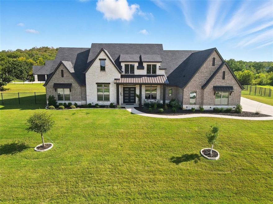 CUSTOM SINGLE STORY 1+ ACRE ESTATE with a 4 CAR GARAGE & UNBEATABLE BACKYARD IN PRESTIGIOUS MONTALCINO ESTATES! Sophisticated luxury meets timeless craftsmanship in this sprawling single-story featuring extensive wood floors, top-of-the-line Pella sliding patio doors, crown molding, decorative lighting & an open-concept floor plan, plus built-in speakers in the family room, primary bedroom & patio. Elevate your culinary game in the thoughtfully designed kitchen boasting quartz & granite counters, under cabinet lighting, large walk-in pantry, farm sink & high-end appliances including a built-in refrigerator & Wolf double ovens & 48 in range top with a griddle. Enjoy gatherings in the impressive family room showcasing a floor-to-ceiling stone fireplace & wood-beamed cathedral ceiling, or work from home in the office graced with French doors & an accent wall. Tucked away at the back of the home, the lavish primary suite boasts an oversized walk-in shower, freestanding tub, separate granite vanities &  massive walk-in closet with built-ins. Just off the primary suite, a versatile flex space offers the perfect spot for a home gym, 2nd office, nursery, or sitting area—whatever suits your lifestyle best. A private guest suite connects to the rear garage with its own entrance, providing ideal accommodations for multigenerational living or guests. Spend time with friends & family in the game room with a snack bar, or watch movies in the secluded media room featuring sliding barn doors, dimmable lighting, surround sound & an equipment closet. Paradise awaits you in the incredible backyard where you can cool off in the PebbleTec pool & spa with tanning ledge lounge chairs, improve your golf game on the putting green, unwind in the outdoor living area with a fireplace or host get-togethers in the cabana with an outdoor kitchen. Montalcino amenities include a gated entrance, clubhouse, pool, fitness center, pickleball, tennis, trails & scenic lake. Attends top-rated Argyle ISD!