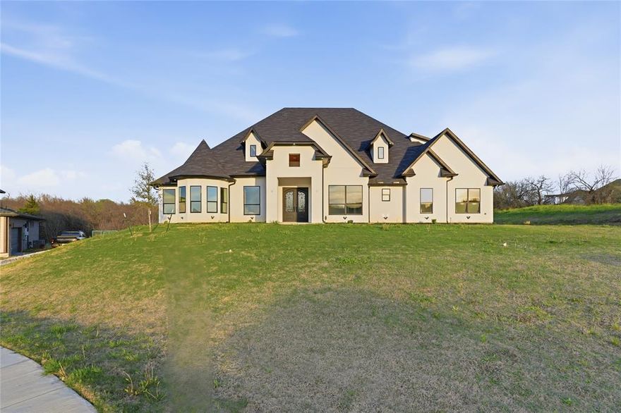 Welcome to 1107 Lily Court, an exceptional estate nestled on 1.7 acres in the highly sought after Lakeridge community of Grand Prairie. This impressive residence offers approximately 5700 square feet of refined living space, thoughtfully designed with both luxury and functionality in mind. Featuring 6 spacious bedrooms and 5.5 beautifully appointed bathrooms, the home showcases a modern open concept layout that creates an immediate sense of grandeur upon entry. Expansive living areas are complemented by an abundance of natural light streaming through oversized windows, enhancing the home’s bright and airy ambiance. At the heart of the home, the chef’s kitchen is a true showpiece, complete with custom cabinetry, high end finishes, and an oversized island perfect for entertaining or everyday living. The seamless flow between the kitchen, dining, and living spaces makes this home ideal for hosting on any scale. The private primary suite serves as a luxurious retreat, featuring its own fireplace and a spa inspired ensuite bath designed for relaxation and comfort. Additional highlights include a dedicated media room, generously sized secondary bedrooms, and thoughtfully designed spaces throughout. Adding to the property’s appeal is a separate guest house, offering privacy and flexibility for visitors, extended family, or potential income opportunities. Situated with convenient access to Highways 67, 287, and I-20, and located within Cedar Hill ISD, this home combines peaceful estate style living with easy access to shopping, dining, and everyday conveniences. Experience the perfect blend of elegance, space, and modern living schedule your private showing today.