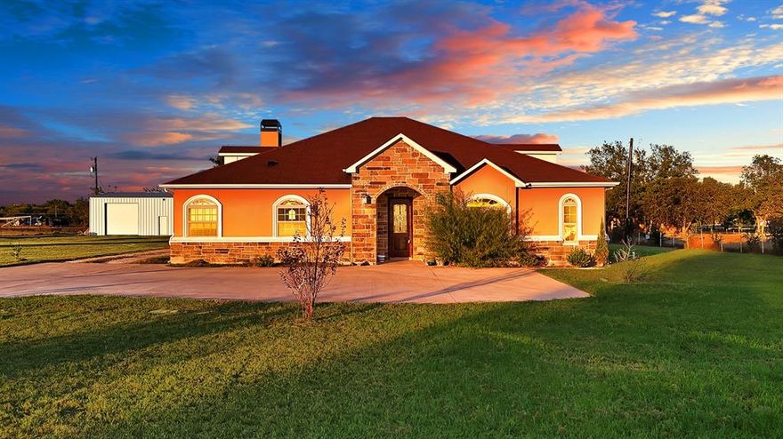 Welcome home to this beautifully designed ranch-style stucco retreat nestled on 1.54 acres of peaceful country land in Terrell, Texas. Built in 2016, this property combines modern elegance, timeless charm, and spacious comfort the perfect sanctuary for anyone seeking room to live, work, and unwind.

Step inside to an inviting open concept floor plan featuring high ceilings, rich hardwood floors, and a stunning stone fireplace as the centerpiece of the living area. Oversized windows fill the home with natural light, creating an airy, welcoming ambiance throughout.

The chef’s kitchen is a showpiece, complete with granite countertops, white custom cabinetry, stainless steel appliances, a large island, and a farmhouse sink. It’s ideal for family gatherings, holiday entertaining, or quiet mornings enjoying the view.

Your primary suite offers a luxurious escape with a spacious bedroom, walk-in closet, and a spa-inspired bathroom featuring a clawfoot soaking tub, dual vanities, and a walk-in shower.

Outside, enjoy Texas sunsets from the covered patio overlooking your expansive yard. The property also includes a large workshop,shed, perfect for RV parking, storage, or hobby space plus ample land for a pool, garden, or outdoor entertaining area.