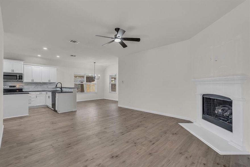 Updated and move in ready.  New LVP flooring.  Kitchen has white cabinets, SS appliances.  Freshly painted.  Updated lighting.  Black fixtures.  covered patio.  sprinkler system.