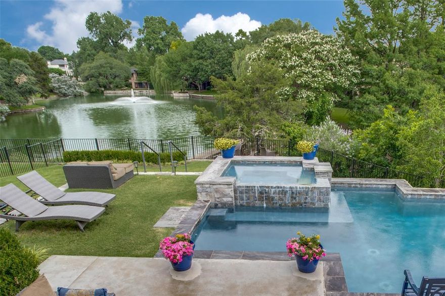 Magnificent transitional masterpiece with waterfront views in Preston Hollow! Soaring ceilings & breathtaking views to this backyard paradise! Sitting outside by the pool you won't believe you are in the city! Gorgeous terraced backyard with resort style pool & hot tub overlooking a private pond w water fountain. Huge beamed covered patio with built-in grill, fireplace & resort style sliding doors. Clean line kitchen offers professional grade Wolf & Sub-Zero appliances & quartz island that overlooks the great room boasting beamed ceiling, open hearth fireplace & wall of windows bringing the outdoors in! Designer touches throughout add a stunning & unique flare to this dream home! Wet bar w bev fridge. Master, office & guest suite down make the perfect floor plan. Master has views to the pond & 2 WIC. Game room, half bath & two bedrooms up with en-suite baths. 2 garages e-epoxy. Homes with this view are a rare find - seeing is believing! House has set-back from Forest on a private road.