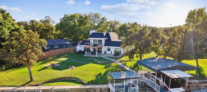 Luxury Lakefront Living, 3 Bedrooms, 3 Baths.  Two Primary Suites, a Bonus Room, & Over 300 ft of Water Frontage with Protected Open Water Access
Welcome to an exceptional waterfront retreat offering refined updates, expansive outdoor living, and rare flexibility with two private primary suites — ideal for multi-generational living, long-term guests, or premium hosting comfort.
Situated on almost a full half an acre at the end of a quiet cul-de-sac in an unincorporated area, this beautifully updated 3-bedroom, 3-bath residence also includes a spacious bonus room perfect for a home office, media room, or additional guest space.
Inside, natural light pours through large windows with stunning lake views from every room. The fully renovated chef’s kitchen features top-tier appliances, custom cabinetry, quartz countertops, and a generous island designed for entertaining. The open-concept living and dining areas flow seamlessly to covered patios and elevated decks overlooking the water.
Both primary suites provide private retreats, with one offering direct access to a lakeside balcony, creating a true owner’s sanctuary with panoramic water views. Outdoor features elevate this property to a true lake lifestyle estate:
Heavy-duty boat lift, Reinforced seawall, Private 2-slip boat dock
 Additional dock designed for entertaining, Expansive covered patio, Multiple viewing decks,  RV hookup for added flexibility• Gently sloping yard with ample space for entertaining, play, or future enhancements, Protected open water access Major waterfront infrastructure has already been completed, offering peace of mind and immediate enjoyment.

This is a rare opportunity to own a turnkey lakefront property with panoramic views, flexible living spaces, and exceptional outdoor amenities.