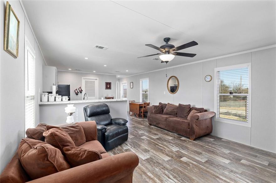 Just blocks from the sparkling waters of Lake Brownwood, this 2026 Champion Home Builders manufactured home delivers that rare combo of “basically brand new” and “already ready for real life.”

Sitting on .44 acres on CR 551, only 10 minutes from Brownwood, this property gives you breathing room without putting you in the middle of nowhere. A 6-foot chain-link fence surrounds the entire yard, complete with a double gate—perfect for pets, projects, boats, or all three.

Inside, the open floor plan makes the home feel larger than its footprint suggests. The living room features a built-in decorative entertainment center that anchors the space and keeps things clean and organized. The kitchen is designed for connection, with an island, breakfast bar, and easy flow into the main living area—ideal for hosting after a day at the lake or enjoying a quiet night in.

You’ll find 3 bedrooms, 2 full baths, washer and dryer hookups, ceiling fans, all LED lighting, and window coverings already in place. No projects. No punch list. Just move-in ready comfort.

Affordable homes—especially in like-new condition—are extremely hard to find right now. This one checks all the boxes: newer construction, fenced yard, land, proximity to the lake, and move-in ready condition. It’s an excellent primary residence, starter home, or weekend retreat near Lake Brownwood—and it won’t last long.