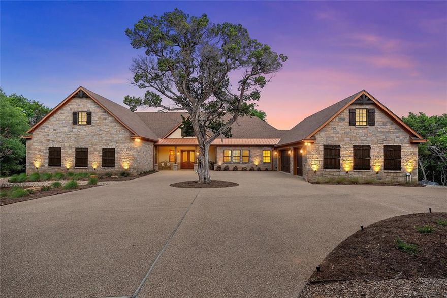 Luxury living on 5.775 Acres in the Hills of Childress Creek in China Spring ISD. Experience unmatched elegance and privacy as you arrive along a picturesque, tree-lined drive to this exceptional 4,331 square foot Brad Alford built custom home, gracefully set on beautifully manicured acres. Designed for both grand entertaining and everyday comfort, this one-of-a-kind residence offers a spacious three-car garage in addition to an oversized RV garage with upper-level storage. Inside, soaring ceilings with exposed wood beams, a dramatic stone fireplace, and grand built-ins create a warm yet sophisticated ambiance. The open-concept design flows effortlessly into a gourmet chef’s kitchen featuring premium Monogram appliances, an expansive center island, and a well-appointed butler’s pantry—perfect for additional refrigeration, wine storage, and seamless hosting.
The secluded primary suite is a true sanctuary, showcasing natural stone accents and a spa-inspired ensuite complete with dual vanities, an expansive walk-in closet, and a luxurious wet room with soaking tub and walk-in shower. Just beyond, a versatile bonus space offers the ideal setting for a private fitness studio, office, or creative retreat. Each additional bedroom is thoughtfully designed with its own en suite bath, while a stately executive office and a light-filled secondary living area provide both function and flexibility. Outdoors, your private retreat awaits. Enjoy a covered patio with a stone fireplace, a relaxing hot tub, and sweeping, unobstructed views of the surrounding landscape—where deer roam and native birds provide a tranquil backdrop. A top tier property that seamlessly blends refined luxury, intentional design, and peaceful country living—this extraordinary property truly stands apart.