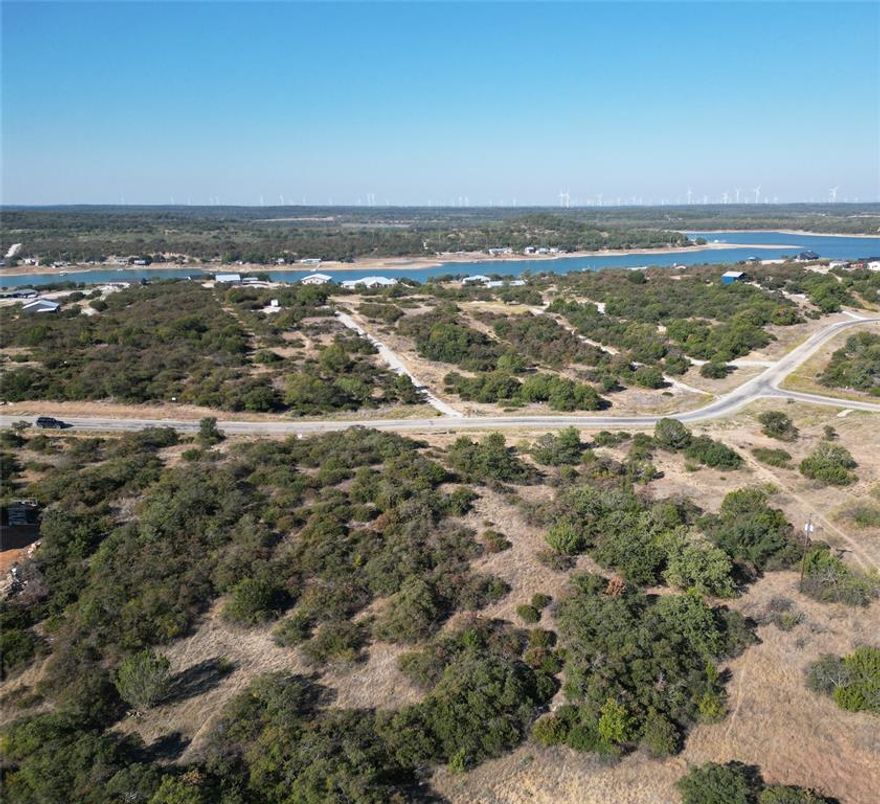 Enjoy peaceful surroundings and scenic views from this hilltop property overlooking Lake Cisco. With views from both the front and back, this spot offers a great opportunity to enjoy lake living in a quiet, natural setting. Located less than 10 minutes from the town of Cisco, you’ll have easy access to local wineries, a brewery, unique restaurants, and boutique shops. The property is also just over an hour from the DFW metroplex and about 45 minutes from Abilene, making it convenient for weekend getaways or full-time living. As part of a private community, you'll have access to a boat ramp and boat slips, perfect for fishing or spending time on the water. Lake Cisco is known for its peaceful atmosphere and great fishing, including largemouth bass, catfish, and crappie. Whether you're looking to build a weekend retreat or a place to settle down, this property offers a relaxing lifestyle in a great location.
