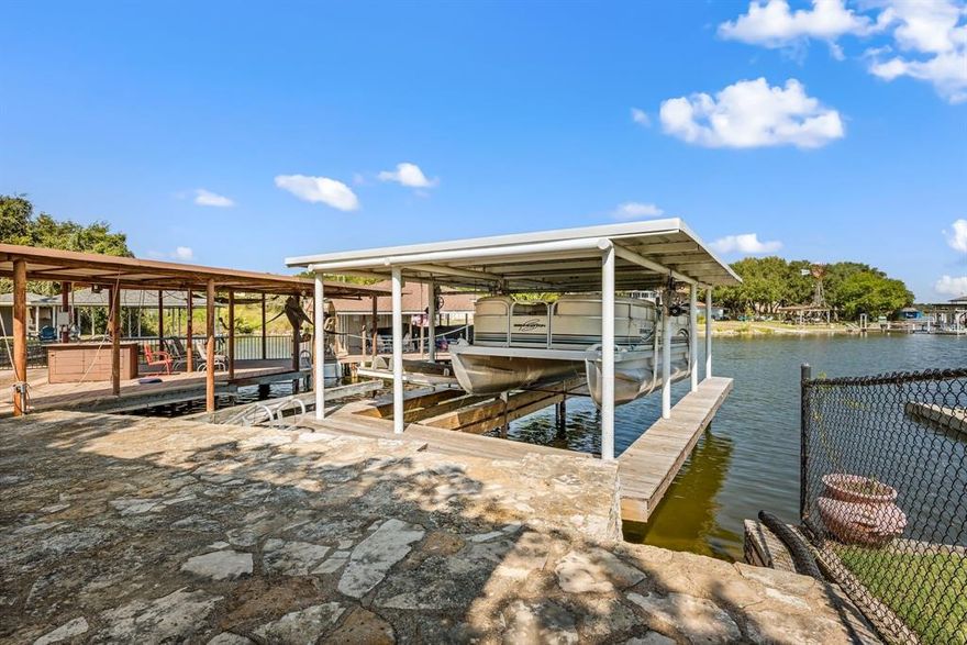 LAKEFRONT living at its finest!! Looking for a home right on the lake? This home checks all the boxes. A major highlight of this property is the fully updated private boat dock, featuring a boat lift plus a separate tandem jet ski lift- all upgraded just two years ago with new wood, cover, lift mechanisms and more. (a 23k investment.) Whether you love boating, fishing, kayaking, or simply relaxing by the water, this lakeside setup is ready to enjoy. There is plenty of covered entertaining space on the patio just steps away from the waters edge. This beautiful maintained 2 bedroom, 2 bath lakehouse overlooks the serene waters of Lake Granbury. Wake up to breathtaking sunrises that paint the sky right outside your window and enjoy peaceful evenings on your private dock. This cozy yet spacious home blends comfort and tranquility, offering an ideal escape for weekend getaways or full time lakeside living. The open concept layout provides seemless flow between the living, kitchen and sunroom areas. Downstairs offers an additional BONUS 624 sqft with a large family room and full bath. Perfect for entertaining or quiet evenings at home. Conveniently located close to Glen Rose and downtown Granbury. Canyon Creek is nestled within a private, gated and guarded communtiy offering exceptional amenities and piece of mind. Turn your dream of paradise into reality. Don't miss out!