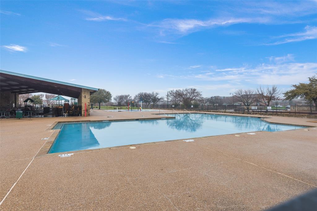 The Seller has got to GO!!!!  Seller is highly Motivated. Welcome Home to this immaculate home in Travis Ranch that offers one of the largest back yards in the subdivision. LOOK At those Beautiful Green Cabinets in your eat in kitchen with a stainless-steel single farmhouse bowl sink, lots of natural light, 2-year-old whirlpool four-piece appliance package, A large kitchen island and a bar overlooking the expansive living area to entertain in. This home offers a flex room off of the living area, 2 bedrooms at the front of the house, a jack n jill bathroom with 2 sinks and a laundry room off of the hall. The primary bedroom is large and is at the back of the home with an ensuite bathroom with double sinks, two shower heads in the huge glass shower and the closet is a must see! The home also offers, tall ceilings, 2-inch faux plantation blinds, 2 car garage, Wood privacy fence around the spacious back yard, a covered backyard patio, rain gutters, no carpet and solar panels that saves you money on your electric bill. Seller can provide the proof on the savings. The seller is willing to help offset the solar panel costs with a competitive offer and contract terms. Enjoy the pool and play areas of Travis Ranch all within a short drive to Dallas and all of the shopping. Call Helena at 910.635.9267 for more information on assuming or leasing options for the solar panels.