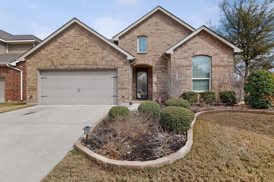 Beautifully maintained one-story home on a corner lot in the highly desirable Kendall subdivision of Lantana .A private study with French doors welcomes you at the front of the home and sits adjacent to a convenient powder bath. The open-concept layout features a spacious dining area and an expansive family room with fireplace, seamlessly connected to the kitchen — ideal for everyday living and entertaining. The chef’s kitchen is equipped with stainless steel appliances, granite countertops, a large island perfect for bar seating, an eat-in breakfast area, and a built-in desk tucked into a separate nook for added functionality. The oversized owner’s suite offers exceptional space and comfort. The en suite bath includes a glass-enclosed shower, tiled garden tub, dual vanities, and a huge walk-in closet. A split-bedroom floor plan provides privacy, with two secondary bedrooms and a full bath located on the opposite side of the home, along with convenient access to the utility room and two-car garage.
Enjoy outdoor living in the beautifully landscaped backyard featuring a mature tree and an extended covered patio — perfect for relaxing or entertaining. Recent updates include Roof (2023), Water heater (2023) .Experience all the wonderful amenities, activities, and lifestyle benefits of master-planned Lantana in this easy-care, move-in ready home!