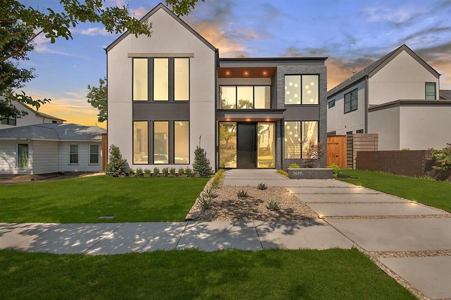 *$10,000 in buyer concessions being offered for a limited time!* Experience elevated modern living in this newly built masterpiece, ideally located in one of Dallas’ most sought-after neighborhoods. The striking stucco and brick façade is enhanced by floor-to-ceiling aluminum windows, flooding the home with natural light and complementing its sleek, contemporary design. Inside, an open-concept layout with soaring ceilings, engineered hardwood floors, Taj Mahal natural stone throughout, and designer finishes creates a seamless flow. The heart of the home is the living and kitchen space, where a gas fireplace wrapped in Taj Mahal natural stone and a built-in wine rack set an inviting tone. The chef’s kitchen boasts a large waterfall island and countertops, hidden walk-in pantry, abundant cabinetry, Sub-Zero, Wolf, Cove appliances, gas cooktop, and Kohler pot filler. The first-floor primary suite offers private backyard access and a spa-like en-suite with floating vanity, walk-in shower, free-standing tub framed by a dramatic accent wall and surrounded by stone rocks, and a custom closet with center island and floor-to-ceiling storage. Also downstairs are a paneled office, a mother-in-law suite with private bath, and a laundry room with sink and chute connecting to both upstairs closets. Upstairs, a versatile game room or flex space with an outdoor balcony joins two additional bedrooms—each with its own bath and walk-in closet. The backyard is perfect for entertaining, featuring a fully equipped outdoor kitchen with Blaze appliances, sink, tiled flooring, and a gated rear entrance. Ample lawn space offers the opportunity to add a pool or customize your outdoor retreat. This energy-efficient, eco-smart home includes foam insulation, hot and cold exterior hose bibs, two Navien tankless water heaters, NUVO water filtration, Tesla universal charger, HomePro security and more. Don't miss out on this new-construction gem!