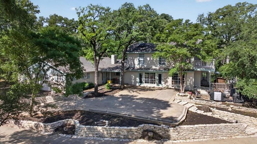 Situated on over 2.5 acres, this recently updated property offers a rare opportunity to enjoy peaceful, country living with convenient city access. 

Surrounded by mature trees, lush greenery, and your very own pond, this property offers privacy with a view. This space is perfectly designed for entertainment or personal enjoyment. 
Just off the backyard deck you'll see a resort style diving pool and spa with an attached pool house for guests. 

Step inside the home to an open main living area featuring expansive windows, modern lighting, and custom wainscoting details.
This property  includes two main living areas with custom details, fireplaces, and generous space for entertaining, complemented by gorgeous scenic views. 

The floor plan offers flexibility with two primary suites, one on each level, each featuring an ensuite bathroom. The main level suite includes a sitting area ideal for guests or multigenerational living. The upstairs suite offers two large closets with custom built ins and an expansive ensuite bathroom with designer touches; including a double vanity, freestanding tub, marble like tile, and wood paneling.

A separate pool house of approximately 400 sq ft includes a kitchenette and full bathroom, offering additional space for guests, entertaining, or private use. 
With a little imagination the large shed with included loft can be turned into another guest house, work shed, garage, gym, or business space! 
Dog lovers and rescuers!! This property offers private commercial grade dog kennels - each with its own attached dog run. Private road located at the rear of the property for additional access and entry options.

This beautifully thought out property offers a unique opportunity for acreage living with functional multigenerational space in a convenient central location.