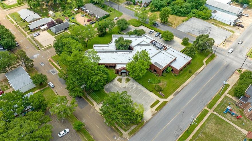 In the heart of downtown Marshall, Tx where sophistication meets convenience in this exceptional commercial office building. This property offers unparalleled opportunities for businesses seeking a dynamic and vibrant environment. Spanning across its well-designed layout, this office building encompasses 13 spacious and versatile offices, with 5 main suit corner offices all with bathrooms and closets. This provides ample space for teams to thrive and collaborate. Each office is meticulously crafted with modern finishes and abundant natural light, fostering an atmosphere of productivity and creativity. Step into sophistication and  functionality with this remarkable commercial property boasting 3 meticulously designed conference rooms.