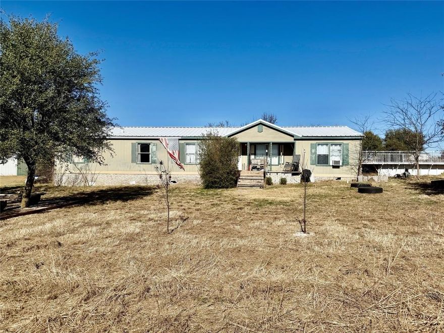 You can come build a gorgeous home on this 5 acres! This property currently has a mobile home and a shop with electricity in shop on the property. 30x40 shop with concrete pad and electricity. Solar panels on grid, New metal roof in 2025, Private well and septic, Fireplace & wood burning stove, Duck pond with coop, Chicken coop and run, Dog run with shed or house, Additional enclosures were used for rabbits, Above ground pool, filter works and is new. Does need a new liner installed. Fruit trees in front yard are peach and plum trees, there is also a peach tree in back that gives fruit. Fire pit in front yard for you to sit out front and enjoy the beautiful sunset. This is a gorgeous piece of property to give the mobile home some TLC or come build your dream home!