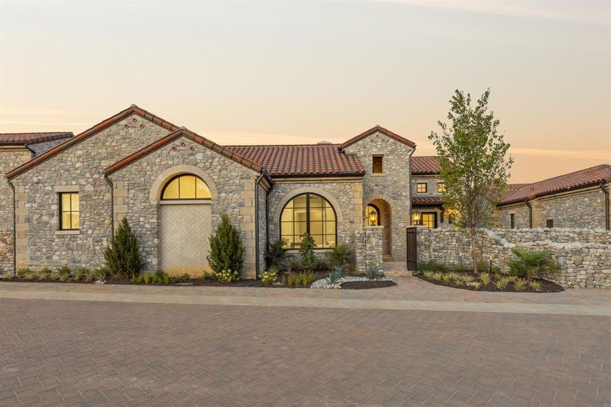 Welcome to 26 Catalonia, a charming one-story residence in the enchanting Westlake Entrada community. Inside, you're greeted by soaring ceilings and a grand arched window that creates an immediate sense of grandeur. The dedicated office offers a peaceful retreat, two en-suite bedrooms that are great for guests, two elegant dining areas, a spacious living room and a game room that caters to both casual and formal gatherings. This home is adorned with custom cabinetry, a cast stone fireplace, and French doors that connect the breakfast area and the game room to a beautiful and private backyard. The owner's suite features his and hers closets, a freestanding tub, Aspen White Dolomite countertops, marble accents, and an exquisite shower for a spa-like experience. The backyard has sweeping hilltop views and the basement 3-car garage with an elevator adds convenience to luxury. Entrada at Westlake is a vibrant community set to offer office spaces, retail, hotels, & dining!