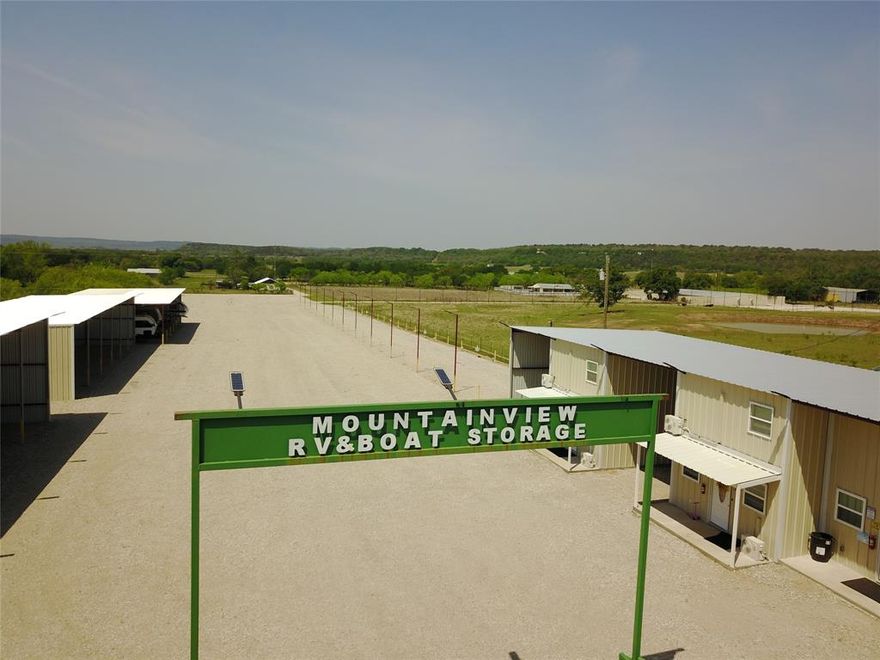 Passive income now boasting of 3 apartments: 2 - 2 story-2 bdrm. and 1 story one bedroom. Includes a laundry mat on site along with carports. RV and Boat Storage of 15 Covered Units and 25 Uncovered Slots (with new additions of 9 RV hookups and 12 water connections available and just needing breaker boxes) with room for expansion. Easy access and close to Brazos River: when you hookup your toys to go to PK Lake and Hells Gate. Office on site: 600 sq ft and great insulation.  Besides this passive income, you have an oversized warehouse of 7710 sq ft with 4 divided large rooms. 3 RR Entrance has counter and cabinets. You decide: your vision is: venues: such as weddings, reunions, dances, battle of the bands, kids' parties...old and young alike. Parking can hold up to 100 vehicles I am told. 2 roll up doors allows easy access to load and unload equipment. Office, cabinets, storage and more storage. Only limits are your imagination. 5 30K BTU heat and air. Ag Exempt 17.281 fenced and cross fenced with private road separating the 3 main areas. 3.2. rocked in mobile home with inground pool. All information deemed reliable and accurate as per sources. Verify all information before entering into contract. No animal or livestock, nor personal property included. If interested in livestock or personal property: please include a Non-Realty Addendum with contract offer.