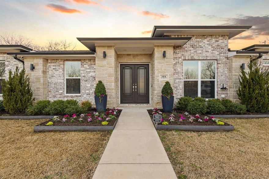 No HOA! No PID! Stunning custom home with a bright, airy single-story floor plan designed for multi-generational living, featuring two full primary suites. The open-concept layout blends comfort and style with architectural details throughout, including elegant coffered ceilings, graceful arches, and a neutral color palette. Step through dramatic double front doors into a welcoming foyer with a private office nearby, perfect for working from home. At the heart of the home, the spacious living area offers both everyday comfort and effortless entertaining, highlighted by a cozy fireplace and easy media setup. The chef-inspired kitchen features stainless steel accents, durable quartz countertops, and an oversized island ideal for meal prep or casual gatherings. Enjoy both counter seating and a dedicated dining area, perfect for everything from homework to hosting guests. The tranquil primary suite offers a spa-inspired bath with dual vanities, a sleek glass-enclosed shower, and a generous walk-in closet. A second primary suite provides additional privacy with its own spacious layout, dual vanities, and custom shower, ideal for extended family or guests. Bedrooms throughout the home are generously sized, including two additional bedrooms, another full bath, and a convenient half bath. Situated on a corner 0.23-acre lot, the outdoor space features a covered patio, storage building, and gated side access, perfect for boat or trailer storage. With double front doors, elegant exterior lighting, professional landscaping, and a durable low-maintenance design, this home offers exceptional curb appeal and everyday functionality. Conveniently located near major thoroughfares and just minutes from Trenton ISD schools, downtown, dining, and shopping, this move-in-ready home is the perfect blend of comfort, flexibility, and convenience. Quick commute to McKinney, Sherman, Bonham & Greenville. Schedule your tour today!