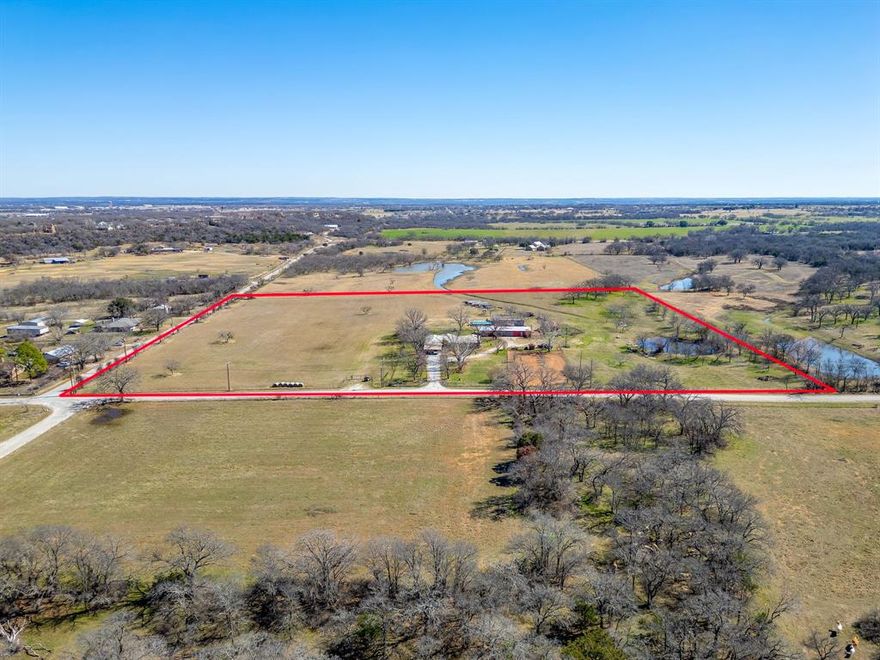 13+ acre AG EXEMPT and UNRESTRICTED North Texas horse country homestead. Exceptional soil is perfect for arenas, round pens, horse runs, pastures, and gardens, making it ideal for horses, cattle, goats, chickens, and 4-H or FFA projects. The property includes good fencing, fenced and cross-fenced, and an older barn with potential for storage, livestock, or a chicken coop, adding even more flexibility for farm and homestead life.

The completely remodeled 3 bedroom, 2 bath, 2 car garage home features knotty alder cabinetry, Level 3 granite countertops, built-in microwave, large island, Monogram 6-burner gas range, custom bathrooms, hardwood features throughout, solid alder doors, and ample storage with walk-in closets in every bedroom.

Outdoor living includes a 28x30 patio plumbed for an outdoor kitchen and full bath, while a 29x30 workshop and a 680 square foot 1 bedroom, 1 bathroom apartment with full kitchen and living area add flexibility for guests, caretakers, or rental income.

The land offers income-producing coastal Bermuda hay fields, a pond, garden areas with exceptional soil, and mature peach, pear, and pecan trees. Additional bonuses include ag-exempt status and a water well to reduce monthly costs. Investors will note the development potential due to proximity to Mineral Wells, Texas, a growing community within an hour of Fort Worth. This property combines horse-ready acreage, homestead and farm living, and income opportunities, offering the best of country life in North Texas.

All information in this listing is deemed reliable but not guaranteed and should be independently verified by the buyer.