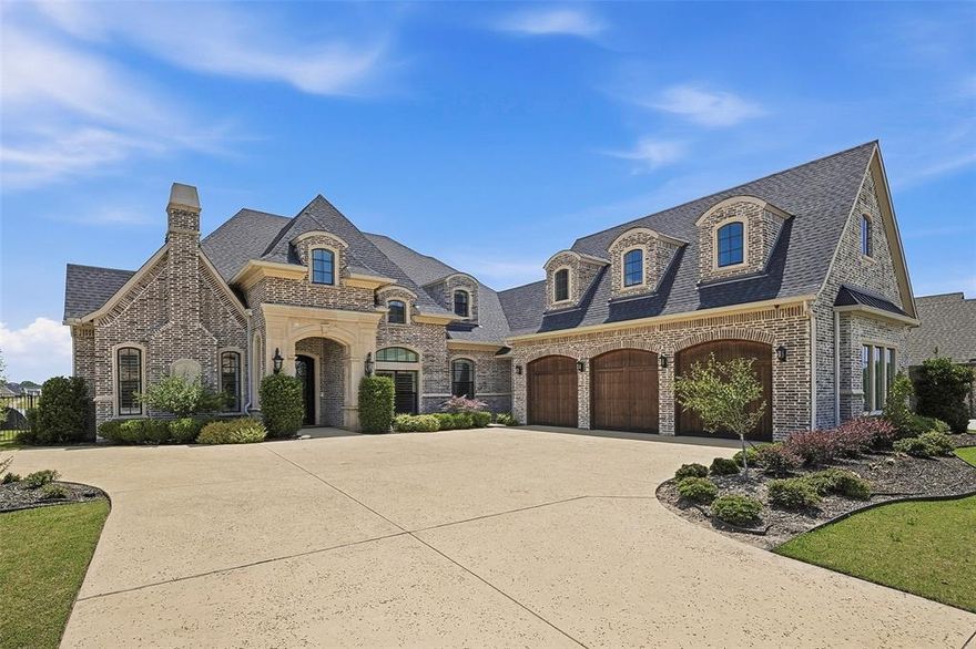 Perfectly positioned along the shores of Eagle Mountain Lake inside the prestigious, guarded, gated Resort community, this custom-built waterfront residence offers a blend of luxury, comfort, and seamless indoor-outdoor living
Built in 2021, this 5-bedroom residence blends sophisticated architecture with livable luxury across an expansive open-concept floor plan.
From the moment you enter, soaring ceilings, designer finishes, and walls of glass frame stunning water views and fill the home with natural light. Elegant formal dining room and private study with fireplace and custom built-ins create inviting spaces for entertaining and everyday living. At the heart of the home, the chef’s kitchen features quartz countertops, abundant cabinetry, premium appliances, an oversized island, and a sunlit breakfast area.
Spacious living room transitions outdoors through dramatic accordion glass doors, creating true indoor-outdoor living. Primary suite is a private retreat with vaulted ceilings, panoramic lake views, a spa-inspired bath with dual vanities, garden soaking tub, oversized walk-in shower, and two generous walk-in closets.
First-floor amenities include a media room, expansive utility room with exceptional storage, dog wash station, dedicated office space, and a built-in safe room-tornado shelter. Upstairs offers two ensuite bedrooms, a versatile flex space, and extensive foam-insulated attic storage with convenient hydraulic lift access from the garage.
Designed for entertaining, the outdoor living experience is second to none with a resort-style pool and spa, remote-controlled electric shades, outdoor fireplace, built-in kitchen, and multiple gathering spaces overlooking the water. The private dock includes a boat slip, room for two jet skis, offering quick canal access to open water!
Complete with a 3-car garage and workshop space, this extraordinary waterfront property delivers luxury, comfort, and the ultimate Eagle Mountain Lake lifestyle.
