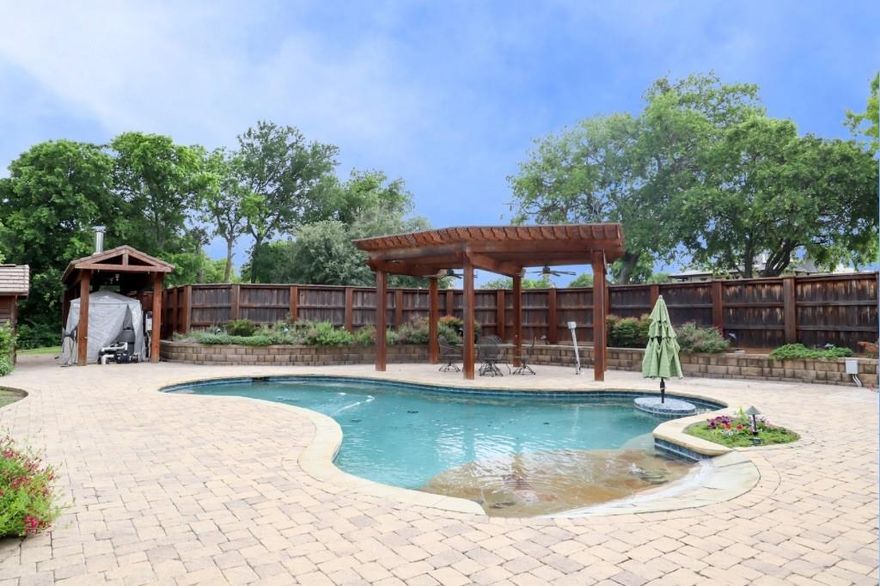 Over 3 acres of everything imaginable! Pool, pond, space for animals, amazing shop, private well, guest quarters, all in the Aledo ISD! Built and cherished by a one owner family,this extraordinary property is more than a home—it’s a legacy. Rich in history and craftsmanship, this remarkable residence is a true testament to its architectural distinction and enduring quality.This stunning two-story home showcases breathtaking features throughout the interior, blending rustic elegance with timeless design.A wood-burning stove beautifully connects the kitchen and living room, creating warmth and ambiance at the heart of the home. The spacious primary suite upstairs offers a peaceful retreat complete with a private ensuite bath,while an optional SECONDARY primary suite on the main floor—also with a full ensuite bath—provides flexibility for guests or multi-generational living. Large windows throughout flood the home with natural light, highlighting the genuine craftsmanship. Step outside to your own private oasis featuring an outdoor pool surrounded by an expansive stone-laid patio. Two pergolas both enhance the outdoor living experience—one poolside and another on the back porch overlooking a serene seasonal pond.For all those who enjoy a shop that has it all-includes a large hand built wood stove and 4 mini splits keeping it nice and cool or warm for all seasons working on those projects.also entails a glassed porch area overlooking the property;Upstairs is a full guest quarters consisting of 2 bedrooms, a full bathroom, bath-shower combo;downstairs includes an additional full bath with shower, and full sized washer-dryer area. The second shop, another area with plenty of space to work on automobiles or projects,comes with plenty of storage. This property includes 3 large solar panels,totally paid for, that result in very attractive utility bills throughout the year. TThe list goes on and the features are endless in this home! Schedule your showing today!