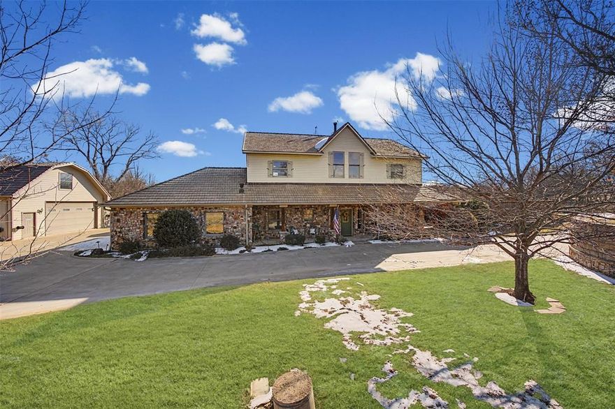 A True Texas Legacy – Award-Winning Timber Frame Estate on over 3 Acres in the Aledo ISD. Built and cherished by a one owner family,this extraordinary property is more than a home—it’s a legacy. Rich in history and craftsmanship, this remarkable residence was once awarded as Texas’ Best Timber Framed Home, a true testament to its architectural distinction and enduring quality.This stunning two-story  home showcases breathtaking timber-framed features throughout the interior, blending rustic elegance with timeless design.A wood-burning stove beautifully connects the kitchen and living room, creating warmth and ambiance at the heart of the home. The spacious primary suite upstairs offers a peaceful retreat complete with a private ensuite bath,while an optional secondary primary suite on the main floor—also with a full ensuite bath—provides flexibility for guests or multi-generational living. Large windows throughout flood the home with natural light, highlighting the genuine craftsmanship. 
Step outside to your own private oasis featuring an outdoor pool surrounded by an expansive stone-laid patio. Two pergolas both enhance the outdoor living experience—one poolside and another on the back porch overlooking a serene seasonal pond.For all those who enjoy a shop that has it all-includes a large hand built wood stove and 4 mini splits keeping it nice and cool or warm for all seasons working on those projects.also entails a glassed porch area overlooking the property;Upstairs is a full guest quarters consisting of 2 bedrooms, a full bathroom, bath-shower combo;downstairs includes an additional full bath with shower, and full sized washer-dryer area. The second shop, another area with plenty of space to work on automobiles or projects,comes with plenty of storage. This property includes 3 large solar panels,totally paid for, that result in very attractive utility bills throughout the year. The features are endless in this home- it's a MUST TOUR to appreciate!