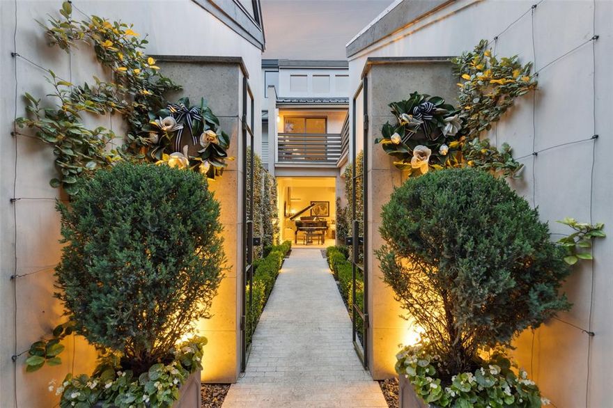 Quite possibly the most beautiful townhome with direct access to the Katy Trail.

Beyond stately iron gates, a manicured courtyard welcomes you with espaliered greenery climbing limestone walls and a tumbled travertine brick path. Inside, the travertine continues through a dramatic great room with soaring double-height ceilings and an abundance of natural light from oversized windows. The open layout is versatile enough to accommodate dining and two seating areas—or even a grand piano. Tucked discreetly off the great room is a built-in bar — complete with space for a wine fridge and elegant storage for your favorite spirits and glassware.

The fully remodeled kitchen is a showpiece, outfitted with Sub-Zero and Bosch appliances, J&K soft-close cabinetry, an apron sink, and a butcher-block breakfast bar. A picture window and double doors frame views of the private outdoor living space and the trail beyond. Step outside to a reimagined deck with Trex flooring, custom planters, and a secure gate offering rare direct access to the Katy Trail.

Upstairs, white oak floors continue the light and airy feel. The primary suite features a private balcony overlooking the trail, automated shades, a cedar-lined closet with hidden pulls, and a spa-like Palladian marble grotto shower. The lofted second bedroom, open to the living space below, includes a guest bath with a striking Japanese soaking tub. A sliding glass door opens to a balcony above the entry and leads to a bonus room—perfect for a home gym, yoga studio, or craft space—not included in the recorded square footage.

Flush and pocket doors, recessed lighting, museum walls, and vintage European fixtures throughout lend a sleek, cosmopolitan aesthetic. Every space has been thoughtfully designed to create a harmonious flow between refined interiors and lush, private exteriors.

Best of all? No HOA—an exceedingly rare find in this area, giving you more freedom and flexibility as a homeowner.