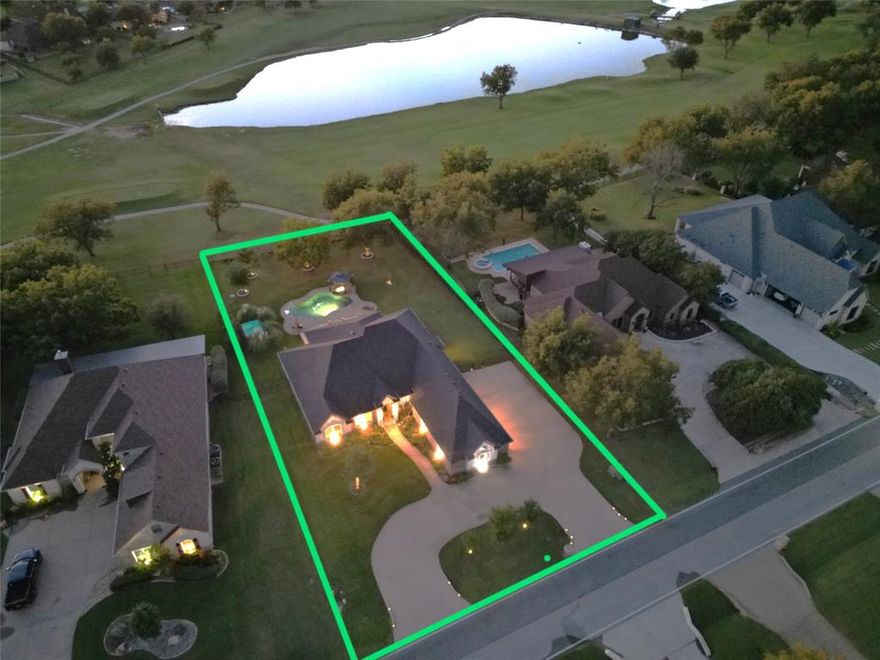 Luxury living on the golf course! Nestled along the 14th hole of the acclaimed Nutcracker Golf Course in Pecan Plantation, this 2014 custom home combines elegance, comfort, and thoughtful design. Situated on over half an acre with serene pond views, a circular drive, and a 3-car garage, it welcomes you with a bright, open floor plan perfect for everyday living and entertaining. The private owner’s suite is split from the guest rooms and features a spa-inspired bath with dual vanities, a jetted tub, walk-in shower, and dream closet connected directly to the utility room. The gourmet kitchen offers granite counters, dual ovens, a decorative vent hood, breakfast bar, dual refrigerator space, and a walk-in pantry with built-in electrical for small appliances. The office with French doors and shutters adds quiet workspace, while the family room’s gas fireplace and golf course views create a warm gathering space. Step outside to your backyard paradise featuring a heated pool and spa, expansive stone patio, outdoor kitchen, and screened-in porch overlooking the fairway. Recent upgrades include a new roof, irrigation improvements, and updated HVAC and pool equipment. A true blend of style and functionality in one of Granbury’s most desirable country club communities.