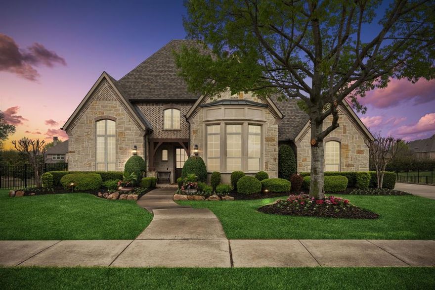 Experience luxury living in this stunning custom home situated in the sought-after Serenity subdivision in Lovejoy ISD. This exquisite residence is designed to entertain on a grand scale with soaring ceilings, hardwood floors, solid doors, intricate lighting, and plantation shutters throughout. The living room and dining room are perfect for formal gatherings with a butler’s pantry leading to your gourmet kitchen fully equipped with a Wolf range, double oven, built-in refrigerator, large walk-in pantry, breakfast bar with seating, and large center island for serving guests. Natural light fills the breakfast room and seamlessly flows to the family room, highlighted by a custom stone fireplace and floor-to-ceiling windows that overlook your outdoor oasis. The primary suite offers an oversized custom closet and spa bath complete with separate vanities, jetted tub, large walk-in shower, and built-in cabinetry with elegant glass panes. The first-floor guest suite and executive office with custom shelving are thoughtfully positioned for privacy. Front and back staircases provide easy access to the game room with a dry bar and beverage fridge, media room, built-in desk area, and three additional bedrooms, each with a private bath and walk-in closet. The mudroom conveniently separates your garage entrance and laundry room with tons of cabinetry, sink, space for a full-sized refrigerator, and exterior access. Step outside to your serene private retreat with multiple areas to relax or entertain. The gazebo features a built-in gas grill, bar with seating, beverage fridge, and dining area ideal for poolside gatherings. Enjoy the covered patio with living and dining space, tranquil pool with peaceful water features, spa, poolside lounging area with built-in gas fire pit, and fully fenced sprawling lawn landscaped to perfection.