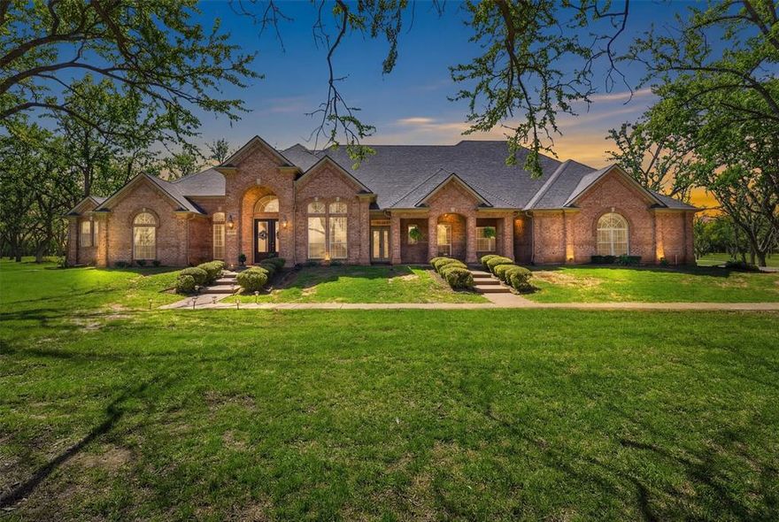 Majestic 4,000+ square foot home with pool nestled among 60 mature trees on a stunning 2.65-acre lot in the highly sought-after Pecan Plantation golfing community. Tucked away on a peaceful cul-de-sac in The Retreat, this property offers a private, park-like setting where you can enjoy birds, deer, and local wildlife from multiple porches and expansive windows.
Designed with custom character and exceptional space for living and entertaining, the home features five bedrooms with split bedroom arrangements, high ceilings, and two inviting fireplaces. There is a warm combination of hardwood floors, tile, and carpet throughout. The spacious kitchen showcases granite countertops, stainless steel appliances, abundant cabinetry, and extensive built-ins for storage.
The flexible floor plan includes an upstairs bedroom or bonus room, perfect for a game room, media room, or private guest suite. Multiple indoor and outdoor gathering spaces create ideal entertainment venues at every turn, while the sparkling pool provides the perfect place to relax in the serene natural surroundings. The property also includes a sprinkler system and generous storage throughout.
Located within the gated Pecan Plantation country club community, residents enjoy premier amenities including 2 championship golf courses, tennis courts, pickle ball, equestrian stables, and a marina on Lake Granbury. The home sits just a stone’s throw from the Brazos River, with five nearby parks providing access for fishing, kayaking, rafting, and outdoor recreation.
Only minutes from charming downtown Historic Granbury with its boutiques, dining, and entertainment, this rare property offers the best of peaceful country living with city convenience. The Dallas–Fort Worth Metroplex is less than an hour away, making this an ideal location for professionals seeking a scenic and relaxing commute.
Don’t miss this rare estate combining space, privacy, natural beauty, and exceptional community amenities.