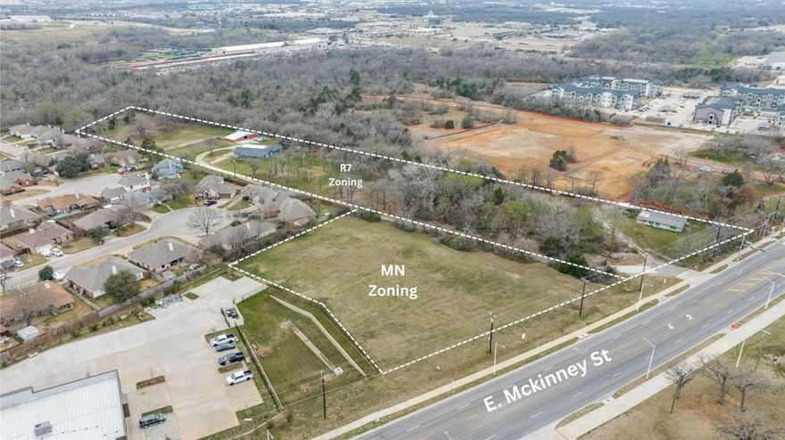 5090–5094–5130 E. McKinney St., Denton, TX presents a rare ±8.5-acre assemblage combining R7 (Residential 7) and MN (Mixed-Use Neighborhood) zoning—delivering scale, flexibility, and entitlement certainty within city limits of Denton. This is a true mixed-density development opportunity positioned along one of Denton’s most active growth corridors.

The ±6.7-acre R7 tract allows single-family detached homes, townhomes, duplexes, triplexes, and fourplexes—ideal for missing-middle housing, build-to-rent communities, or small-lot residential product. The adjacent ±1.7-acre MN parcel supports neighborhood retail, medical or professional office, live-work concepts, multifamily, civic space, and limited commercial uses. Together, the zoning framework enables a cohesive master-planned concept integrating residential rooftops with neighborhood-serving commercial activation.

Strategically located along high-visibility E. McKinney Street, the property sits directly across from Billy Ryan High School, generating consistent daily traffic and long-term residential demand support. Access to Mayhill Road and Loop 288 enhances connectivity to employment centers, healthcare, and established neighborhoods—supporting strong absorption fundamentals.

This 8.5-acre footprint allows developers to control both density and activation within one unified plan. Execute a phased residential rollout while activating commercial frontage to serve incoming rooftops. The entitlement structure reduces zoning risk and shortens development timelines, allowing focus on engineering, site planning, and capital deployment.

Mid-size entitled tracts offering both residential density and mixed-use frontage are increasingly limited in Denton. For developers and investors seeking corridor positioning, scalable yield, and product flexibility in a high-growth North Texas submarket, this assemblage represents a developer-ready asset with measurable execution-driven upside.