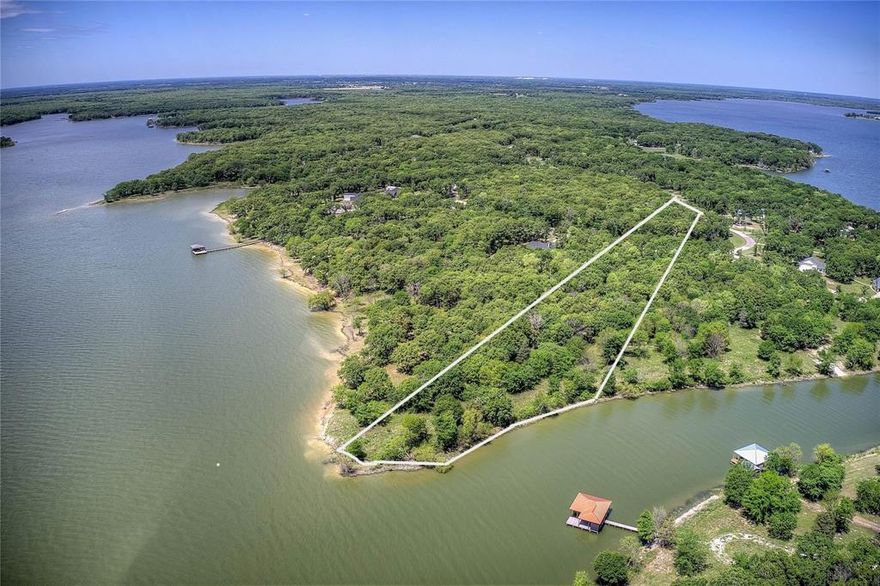 Build Immediately on 1+ Acre Lakefront Lot with 4.5 Acres Usable, Utilities Installed, Largest in Nautical Shores. 

BUILD NOW — no waiting, no guesswork. This rare 1.03-acre lakefront lot in Nautical Shores is fully prepped and ready for construction, saving you months of time and upfront work. With utilities already installed, land cleared, and build requirements completed, you can move straight to building your lake home. What makes this property stand out is not just the size, but the usability. You’ll enjoy over 4.5 acres of total usable space, including an additional 3.48 acres of protected shoreline through the Sabine River Authority, giving you privacy, natural beauty, and direct lake access without neighbors behind you.

The lot is level, cleared, and surrounded by mature hardwoods, including a remarkable centuries-old oak. When water levels recede, a natural sandy shoreline emerges, creating a unique lakefront experience rarely found in this area.

Unlike most lots, everything needed to start building has already been completed. Soil testing, survey, utilities, and site preparation are done. This eliminates months of delays, unexpected costs, and uncertainty, allowing you to focus on designing and building your home immediately.


Skip the time, hassle, and expense — this property is already prepared for construction:

Soil testing completed
Survey completed
Utility meter installed on-site
Site cleared and prepped for building
Approved sewage permitting completed
Architectural plans available 

1.03-acre deeded lot
Approx. 3.48-acre leaseback (SRA)
Total usable space approx. 4.51 acres
HOA: $600-year
Optional boat slip: $500-year
SRA leaseback: approx. $50-year with permit
Dock and pier permitted (up to 150 ft, subject to approval)
Minimum build: 1,400 sq ft (single story), 1,800 sq ft (two story)

Opportunities like this — a build-ready, lakefront lot of this size and usability — are extremely limited in Nautical Shores.