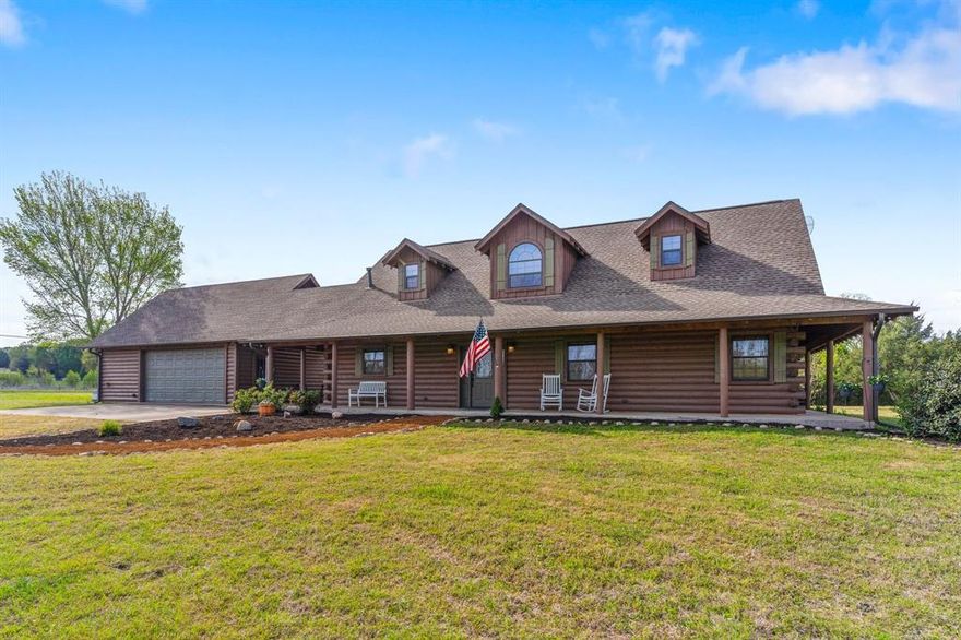 Set on 7.6 acres with a beautifully balanced landscape with open usable land in the front and mature woods in the back this stunning energy efficient Satterwhite Log Home offers a rare blend of privacy natural beauty and peaceful surroundings. A winding creek and scenic views create a tranquil retreat like setting that feels worlds away from it all.

Inside you are welcomed by a dramatic open concept design with soaring ceilings a grand entry and rich solid hickory flooring throughout. Expansive windows flood the home with natural light and frame the surrounding landscape seamlessly bringing the outdoors in. The spacious living area is anchored by a striking two story stone fireplace creating a warm and inviting focal point.

The kitchen is thoughtfully designed for both everyday living and entertaining featuring a Viking six burner cooktop double ovens and abundant cabinetry. A generously sized dining area provides the perfect space to gather with family and guests. A main level office offers a quiet space for working from home or reading adding functionality to this exceptional layout.

The private owners suite located on the main level offers a peaceful escape with a cozy sitting area spa-like bath garden tub separate shower and a large walk in closet. Upstairs a versatile flex space can easily serve as a game room media room or second living area. Two well sized secondary bedrooms with walk in closets and a full bath complete the second floor.

Outside the property continues to impress with a large garage featuring a newly applied epoxy floor built in workspace and two extra storage rooms providing ample room for projects equipment or hobbies. Paid off solar panels provide long term savings and environmentally conscious living. Whether you are entertaining relaxing or simply enjoying the quiet beauty of nature this one of a kind property delivers the perfect balance of rustic charm and modern comfort.