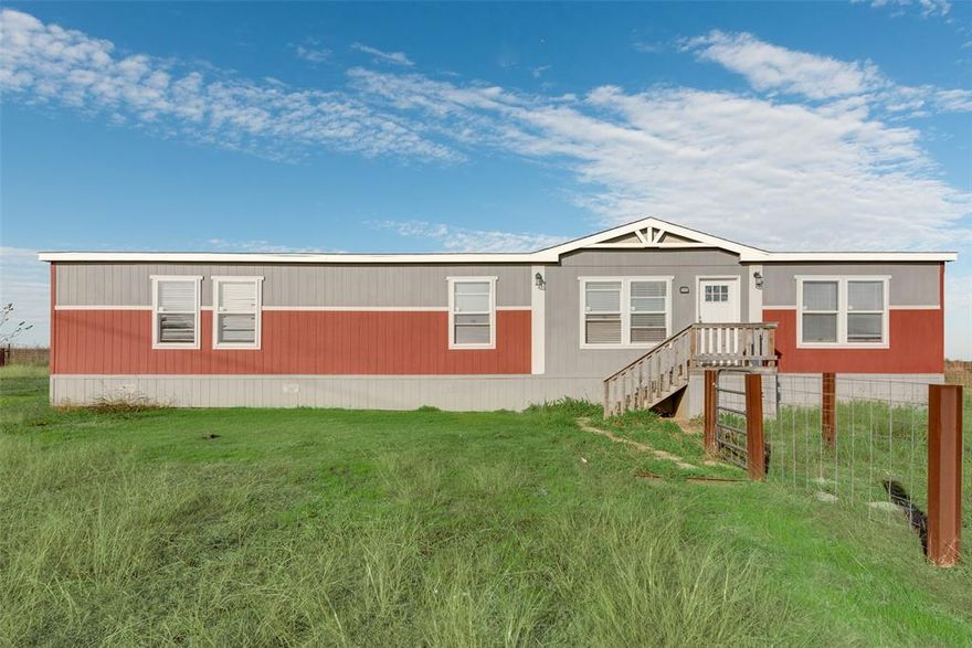 Discover the perfect blend of comfort and country living  in this beautifully designed doublewide mobile home built in 2021 situated on a fully fenced 1-acre lot. This 4 bedroom home offers spacious living with a variety of modern amenities. The 2nd living area features ceiling fan recessed lighting, providing a warm and inviting atmosphere perfect for entertaining. Cook in style in the open kitchen equipped with an island, smooth top range, and built-in microwave. A convenient farm sink and shelving in the pantry. The primary suite, complete with recessed lighting and a relaxing bathroom that includes a double sink, garden tub, separate shower, and a huge closet. Roof replaced fall of 2025.  Enjoy the comfort and privacy of a fully fenced yard, offering space for gardening, relaxation, and outdoor activities. Ready to move in.