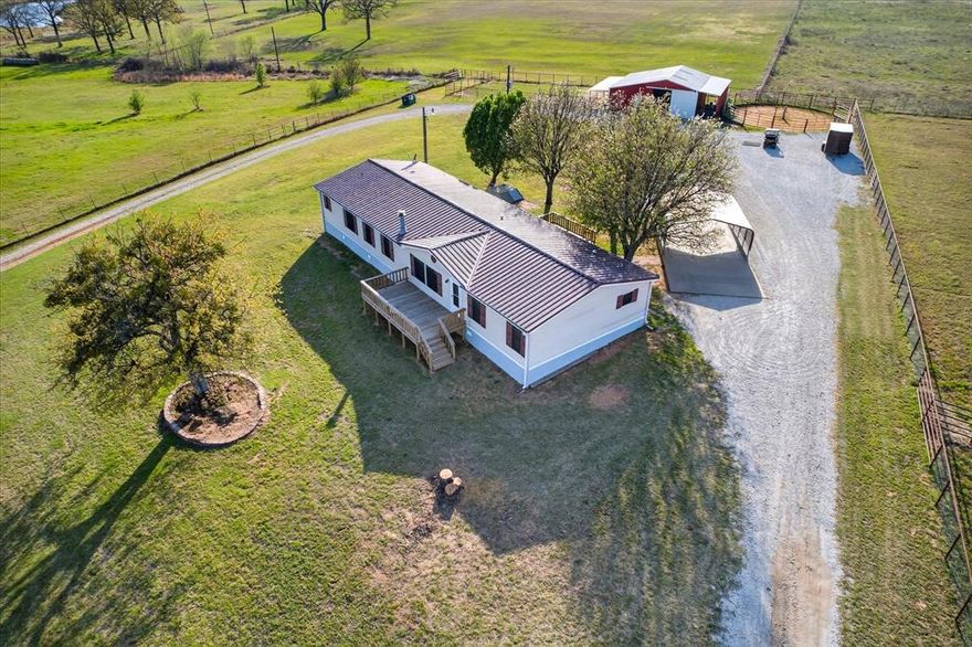 Welcome to your truly turnkey horse property in Whitesboro - offering the perfect blend of functionality, comfort, and scenic country living, all under $500K! Situated on over 5 fully fenced acres of sandy loam soil with pipe and no-climb fencing, this prime equine property is thoughtfully designed with both horse and rider in mind. The barn features automatic waterers in every stall, an added paddock, and a newly constructed tractor shed for added convenience. Enjoy breathtaking hillside views and the peace and privacy of quiet country living, all while being in a highly desirable horse-friendly area. The property also includes a 36x36 shop complete with a concrete floor, electricity, water, and a 10’ lean-to carport with concrete pad—perfect for equipment, trailers, or additional workspace. The beautifully maintained 5-bedroom, 3-bath manufactured home offers plenty of space for family and guests, along with large front and rear porches ideal for relaxing or entertaining while taking in the serene surroundings. Whether you're a seasoned equestrian or simply looking for a slice of Texas countryside, this property is fully equipped and ready to go!