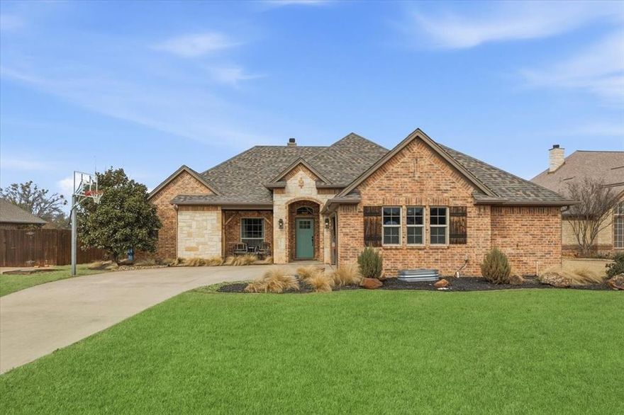 Centrally located in Aledo, this move-in ready single story brick and stone home features inviting curb appeal, a functional open layout, and new interior paint! Inside, wood flooring runs through the main living spaces and the layout flows easily for everyday living and entertaining. A formal dining room sits off the entry and connects naturally to the kitchen and living area. The living room features a brick fireplace, tray ceiling, and large windows that bring in natural light. The kitchen is open to the living space and offers granite countertops, extensive solid wood cabinetry, stainless steel appliances, gas cooktop, large island, pendant lighting, and bar seating. A breakfast area provides additional casual dining space. The private primary suite features vaulted ceilings and a spacious bath with dual vanities, soaking tub, separate shower, and walk in closet. Secondary bedrooms are well sized with flexible options for office or guest space. Laundry room includes built in cabinetry and storage. The backyard offers a covered patio and a large fenced yard with plenty of room to add a pool, play space, or garden. All of this, plus a new roof in 2023, means this home is ready to go! Don't miss it!